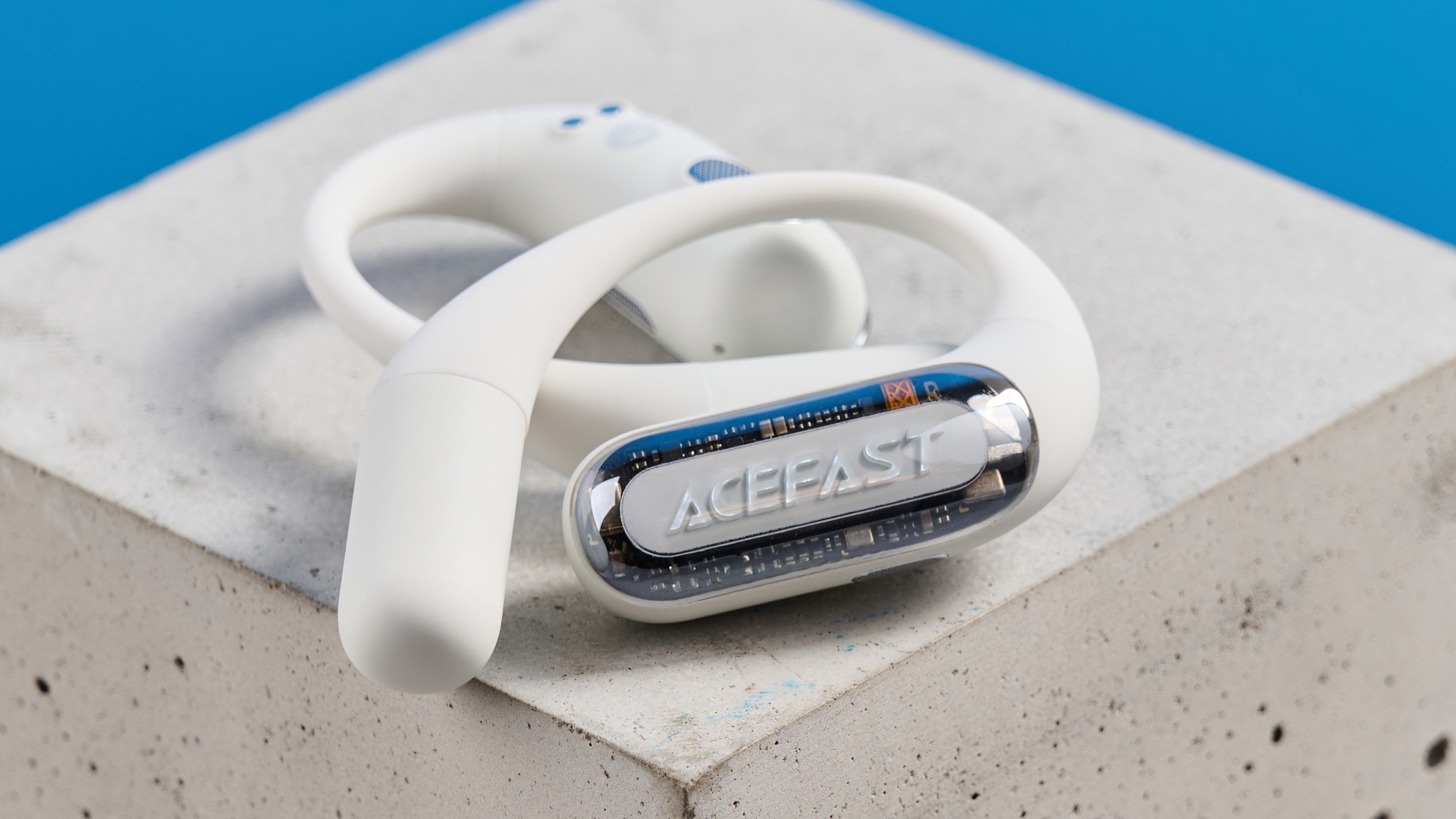 AceFast AceFit Pro open earbuds and the light up charging case photographed in front of a blue background.