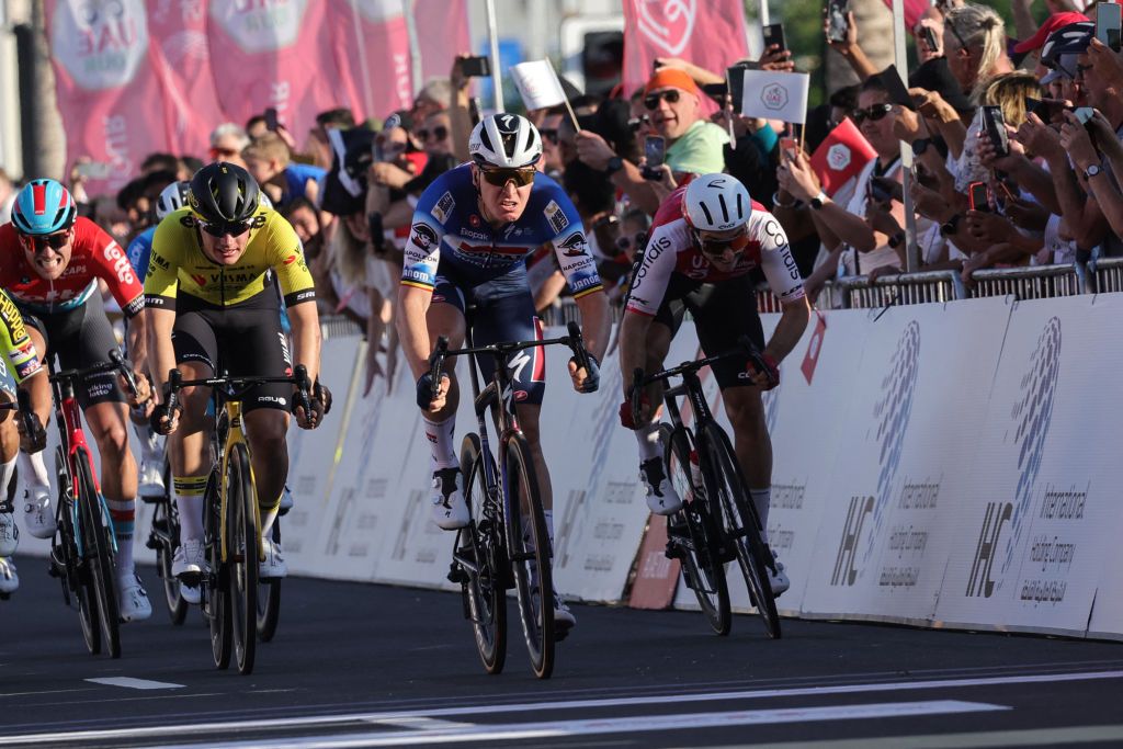 Soudal-Quick Step Team's Belgian cyclist Tim Merlier (C) pedals to win the fourth stage of the 6th UAE Cycling Tour, in Dubai, on February 22, 2024. (Photo by Giuseppe CACACE / AFP)