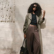 emmanuelle wearing a trench coat and pants
