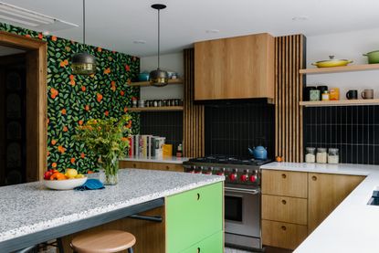 a kitchen with an orange wallpaper