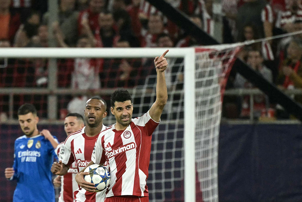 Olympiakos' Iranian forward #99 Mehdi Taremi (R) celebrates after scoring Olympiakos' second goal during the UEFA Champions League, league phase - matchday 5, football match between Olympiakos (GRE) and Real Madrid (ESP) at the Georgios Karaiskakis Stadium in Piraeus on November 26, 2025. (Photo by Angelos Tzortzinis / AFP)