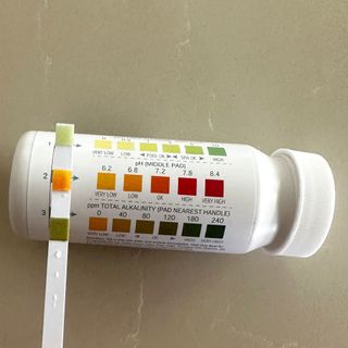 A hot tub testing kit with multicoloured strips