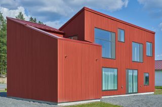 red exterior and large windows of Simonsson House, Sweden, by Claesson Koivisto Rune