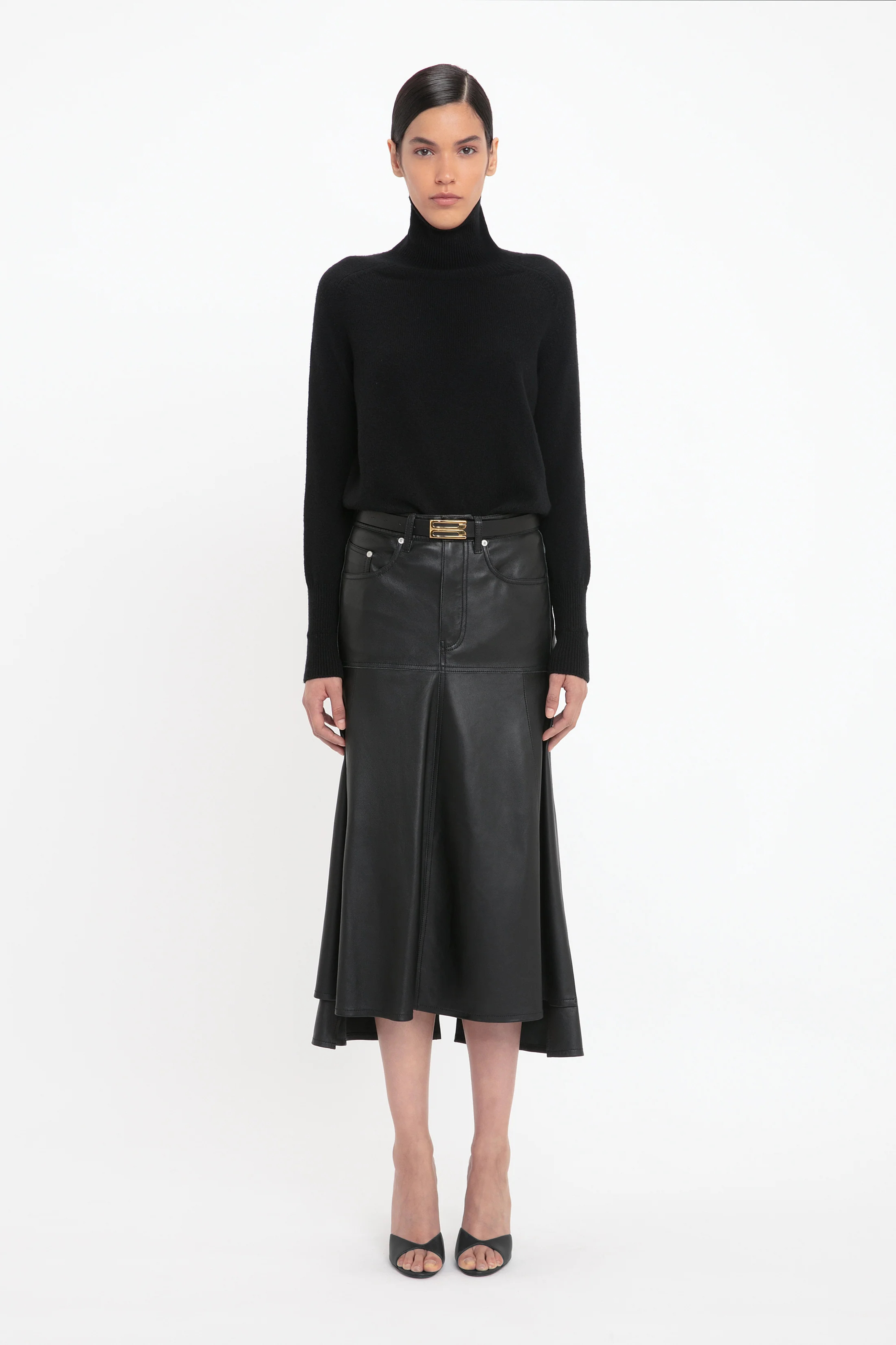 A model wearing a Victoria Beckham leather midi skirt. 