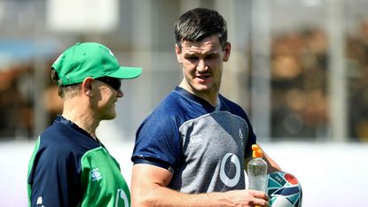 Ireland head coach Joe Schmidt speaks with fly-half Jonathan Sexton during training 