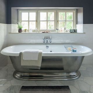 bathroom with misty fjord floor tiles and tay roll top bath