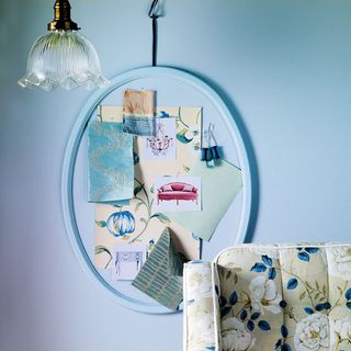 blue wall with hanging lamp and cloth pieces
