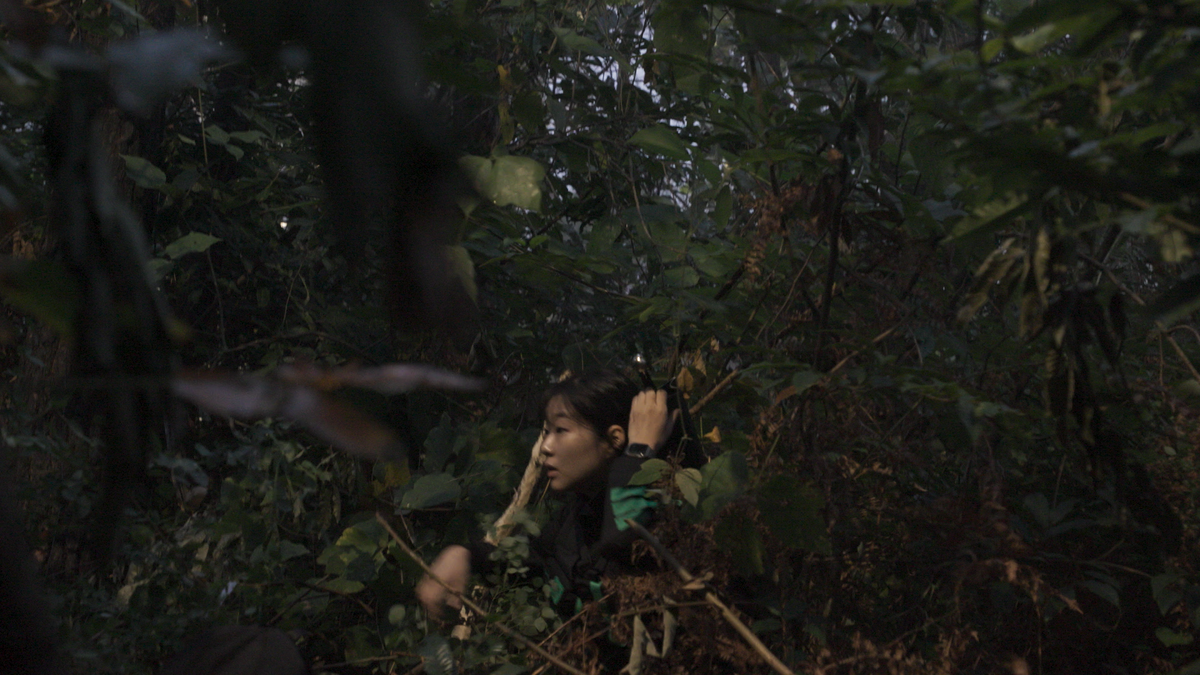 One Siren: Survive the Island contestant hiding in foliage