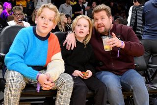 James Corden and his two kids Max and Carey watching a basketball game