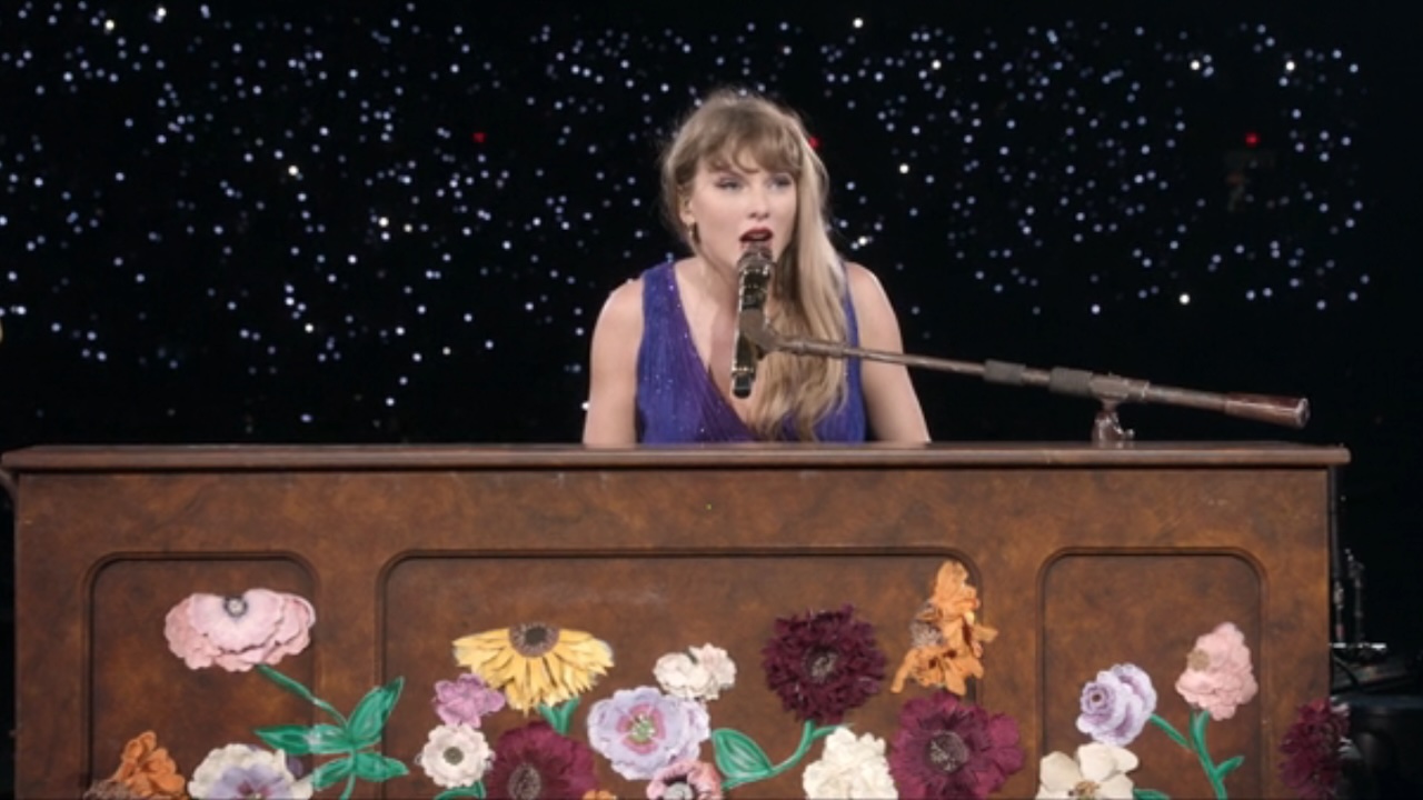 Taylor Swift singing and playing piano at The Eras Tour