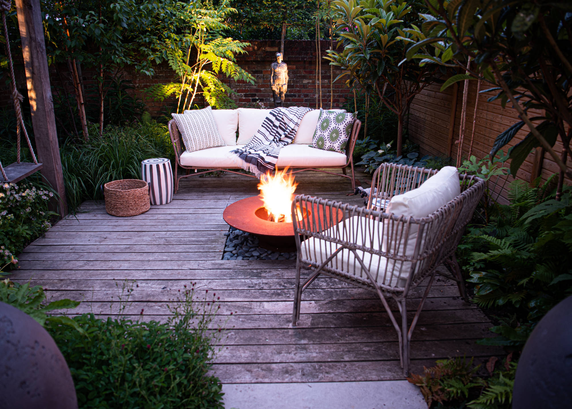 outdoor sitting area on a paved patio with a firepit in the middle
