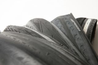 A selection of bike tyres lay on a white surface