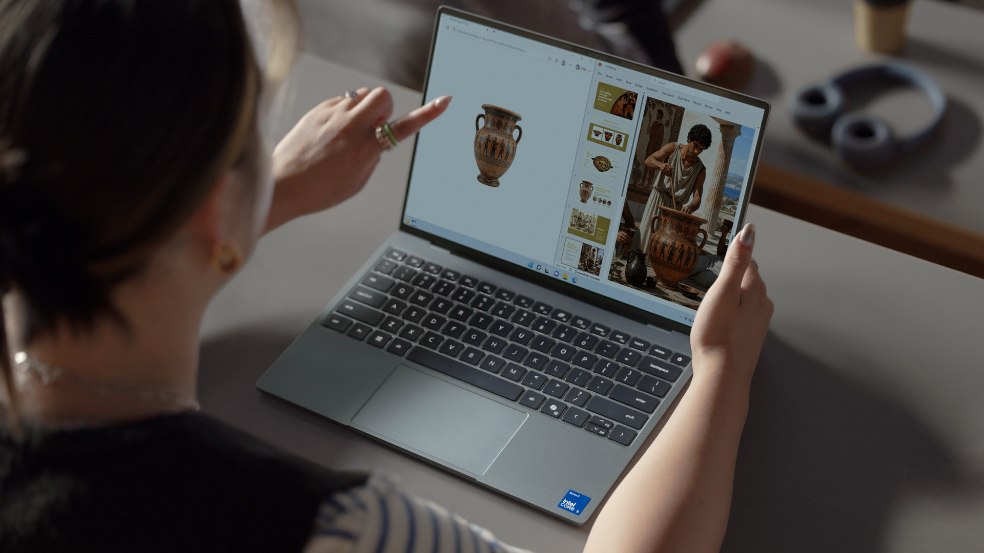 Dell XPS 13 on a desk, a person is using the touchscreen