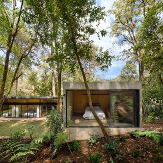 Casa El Pinar, sitting among trees with open windows, looking in