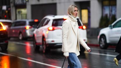 Woman in jeans crossing road