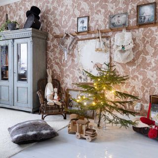 childrens christmas bedroom with wallpaper, vintage furniture and small tree