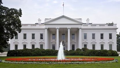 Grass, Property, Garden, Landmark, Flag, Government, Real estate, Shrub, Fountain, Water feature, 