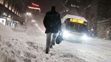 A bomb cyclone dumped snow across the Northeast in January 2018 as well. Here, a man walks through the streets of Boston as snow falls from the massive winter storm on Jan. 4, 2018 in Boston. 