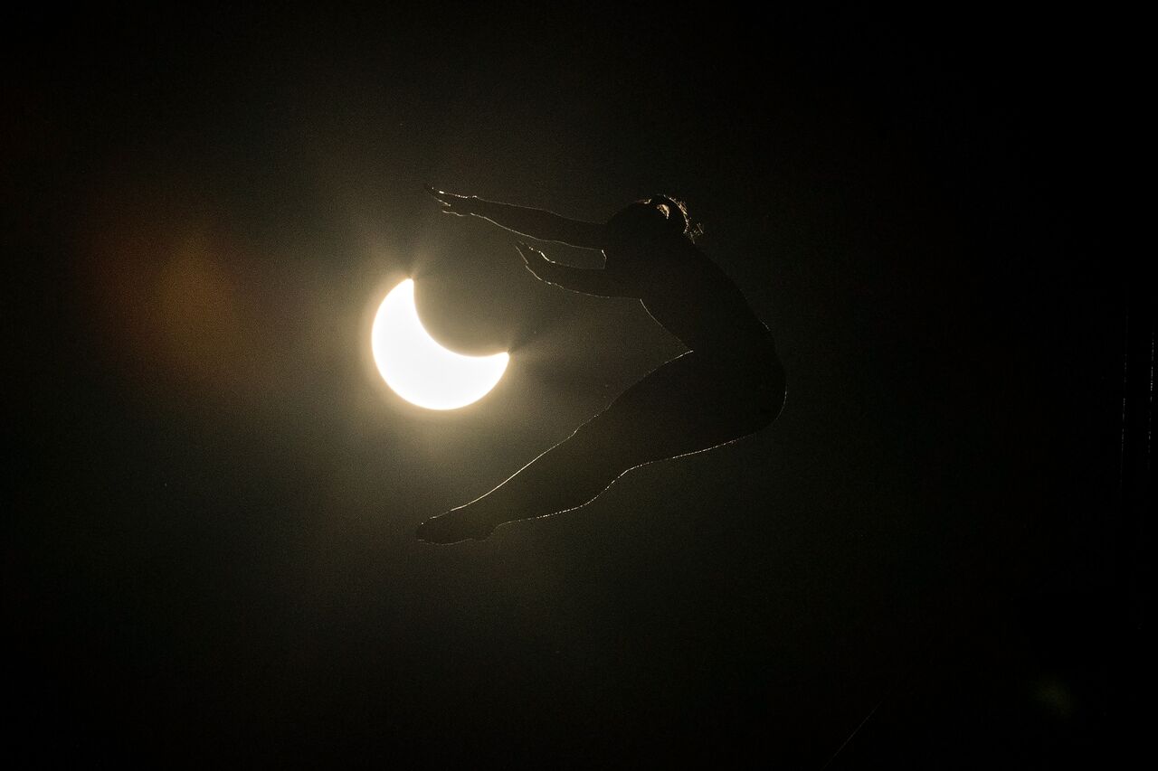 On Aug. 21, cliff divers in McMinnville, Oregon dove into a water tank against the backdrop of the solar eclipse.