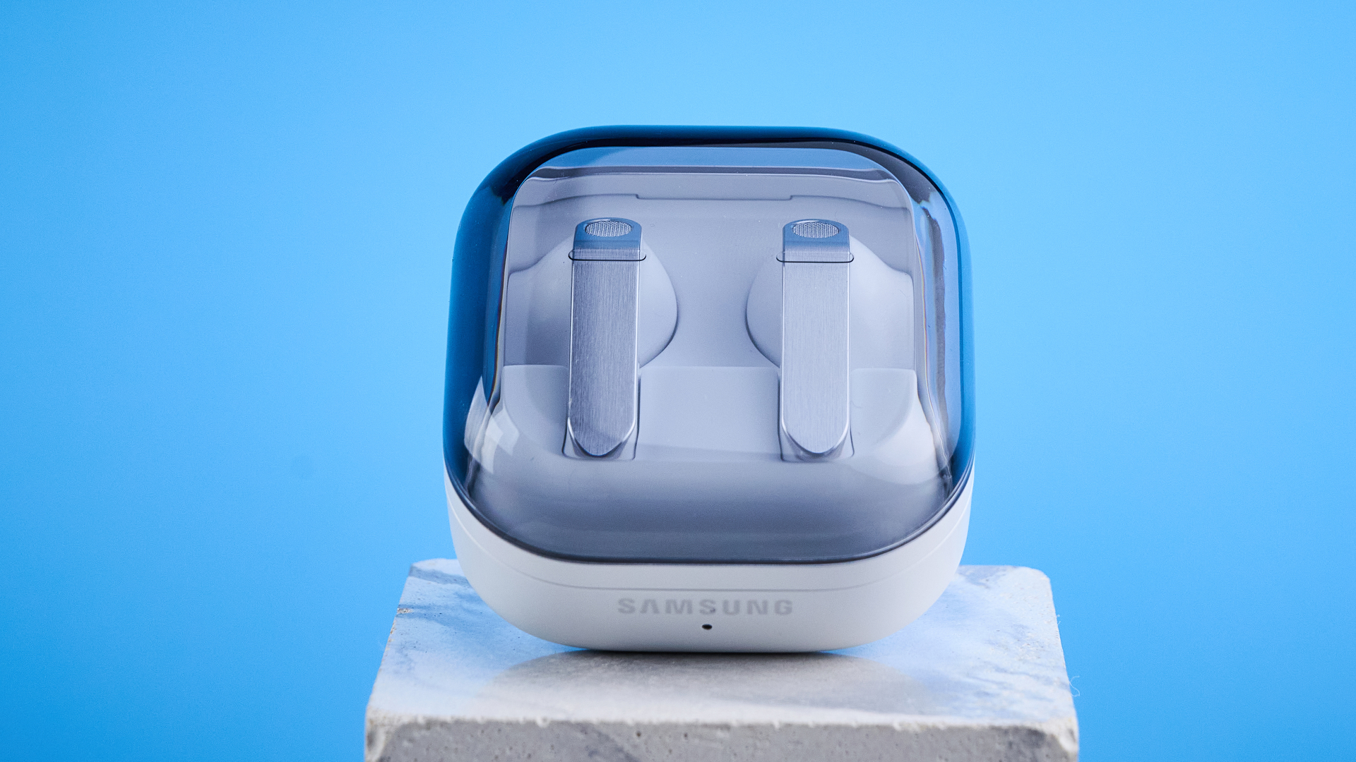 the samsung galaxy buds 4 photographed against the blue tom's guide background showing charging case and buds