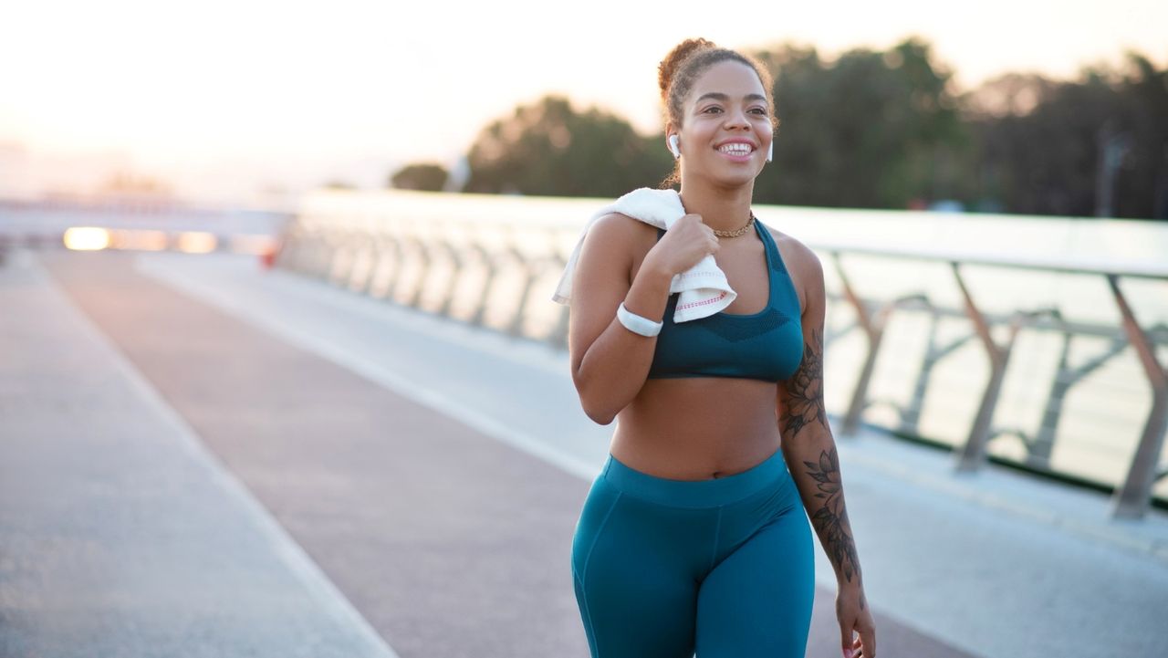 Attractive women walking on a bridge with a towel thrown over her shoulder