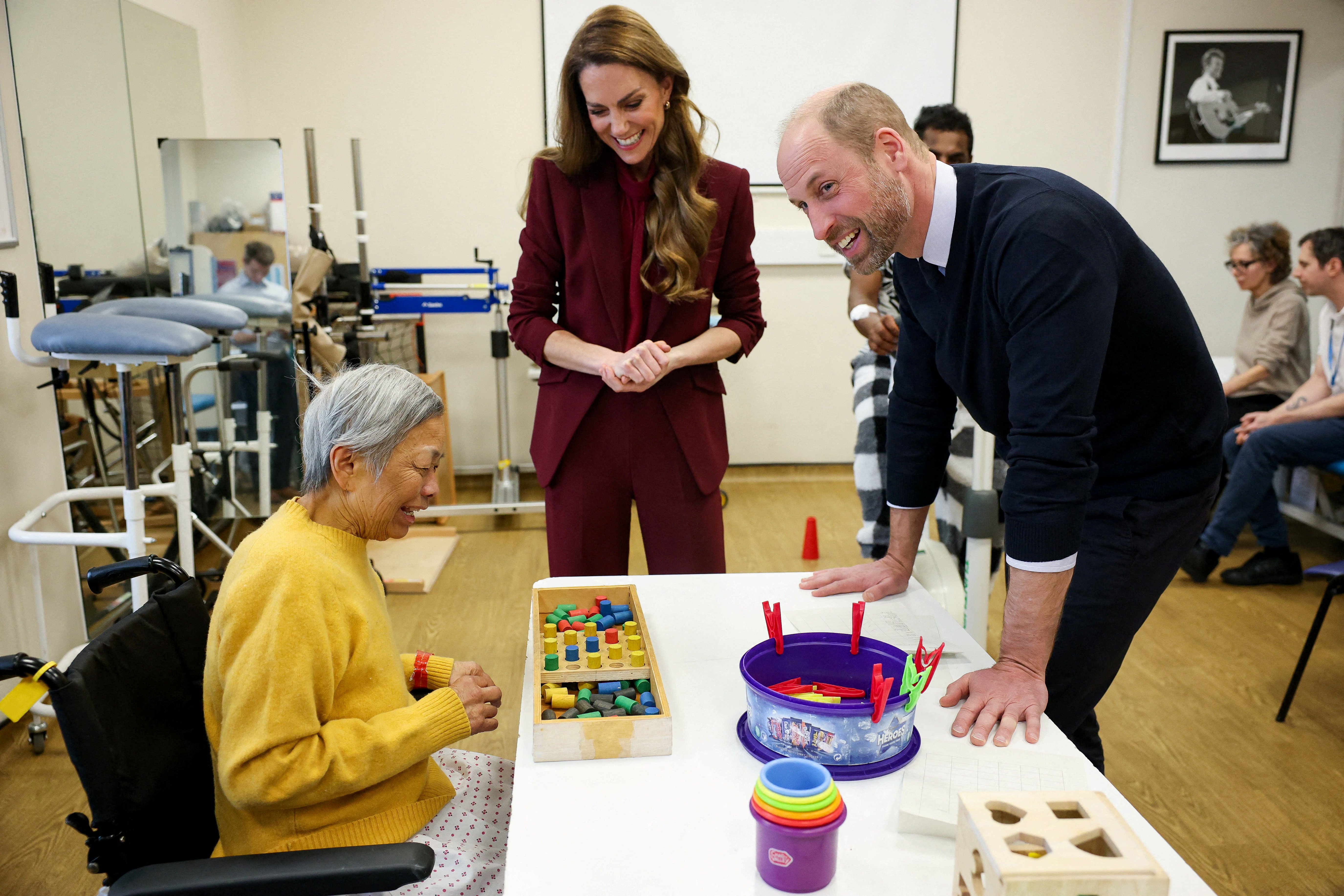 Prince William and Princess Kate meet with volunteers at a hospital in London.