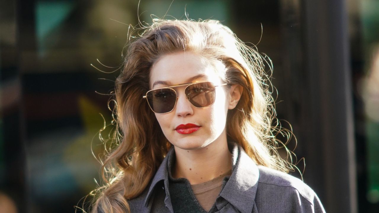 paris, france february 26 gigi hadid wears sunglasses, a gray jacket, a green wool pullover, outside lanvin, during paris fashion week womenswear fallwinter 20202021, on february 26, 2020 in paris, france photo by edward berthelotgetty images