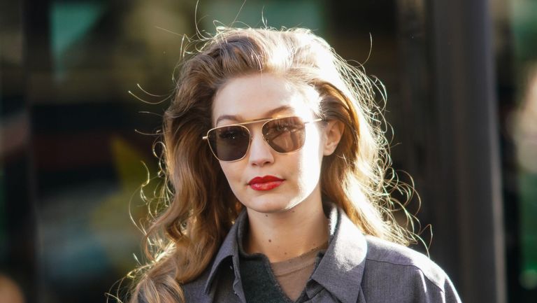 paris, france february 26 gigi hadid wears sunglasses, a gray jacket, a green wool pullover, outside lanvin, during paris fashion week womenswear fallwinter 20202021, on february 26, 2020 in paris, france photo by edward berthelotgetty images
