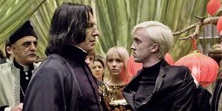 Alan Rickman and Tom Felton as Snape and Draco looking at each other in Harry Potter