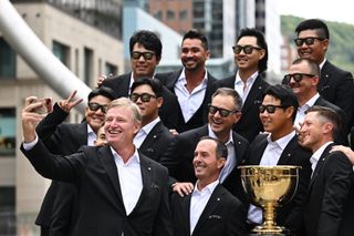 Ernie Els holds his phone for a selfie