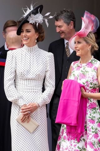 Catherine, Princess of Wales, carries a cream clutch bag, with Sophie, Duchess of Edinburgh during the Order Of The Garter Service at Windsor Castle on June 19, 2023 in Windsor, England.