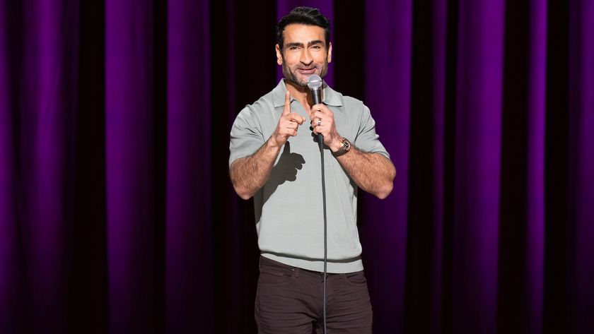 Kumail Nanjiani on stage in front of a purple curtain in Night Thoughts