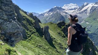 A woman trail running in the Alps