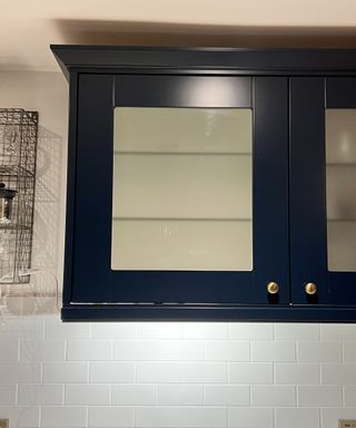 Navy kitchen cabinet with white splashback