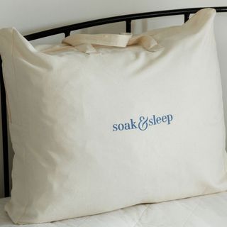 white cotton storage bag from Soak & Sleep on a bed