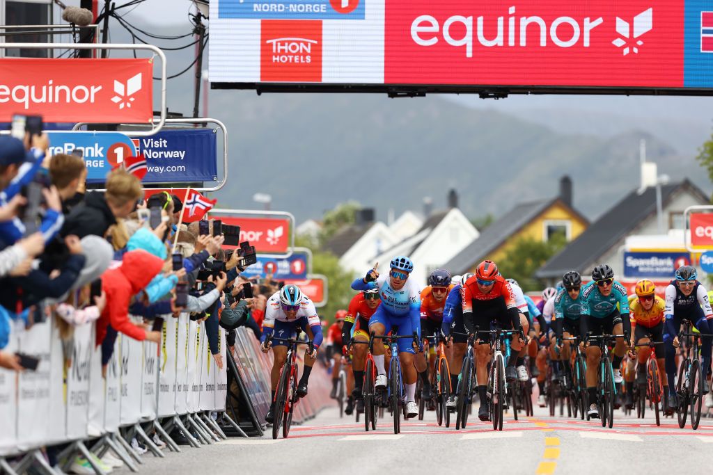 BRONNOYSUND NORWAY AUGUST 12 Dylan Groenewegen of Netherlands and Team BikeExchange Jayco celebrates at finish line as stage winner ahead of Edvald Boasson Hagen of Norway and Team Total Energies L and Amaury Capiot of Belgium and Team Arka Samsic R during the 9th Arctic Race Of Norway 2022 Stage 2 a 1543km stage from Mosjen to Brnnysund ArcticRace on August 12 2022 in Bronnoysund Norway Photo by Michael SteeleGetty Images