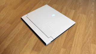 Alienware x14 laptop closed on wooden table
