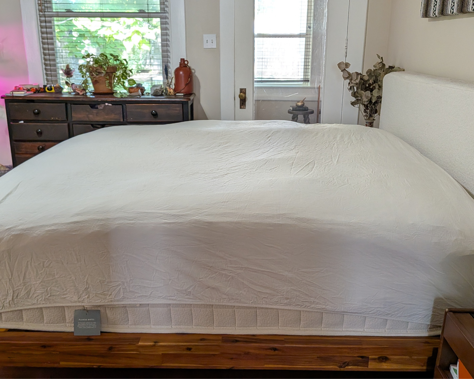 A fitted sheet placed over the Avocado Down Mattress Topper.