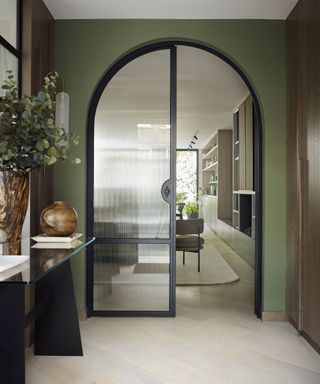 Green contemporary hallway with arched glazed doors with fluted glass. Interior by Gunter & Co, photograph Mary Wadsworth