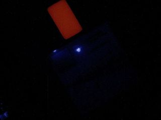 This image of a calibration target illuminated by ultraviolet LEDs (light emitting diodes) is part of the first set of nighttime images taken by the Mars Hand Lens Imager (MAHLI) camera at the end of the robotic arm of NASA's Mars rover Curiosity. Image released Jan. 24, 2013.