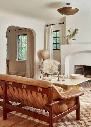 a living room with a leather sofa and checkerboard rug