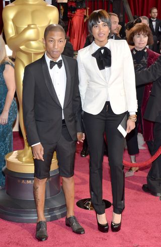 Musician Pharrell Williams (L) and wife Helen Lasichanh attend the Oscars held at Hollywood & Highland Center on March 2, 2014 in Hollywood, California.