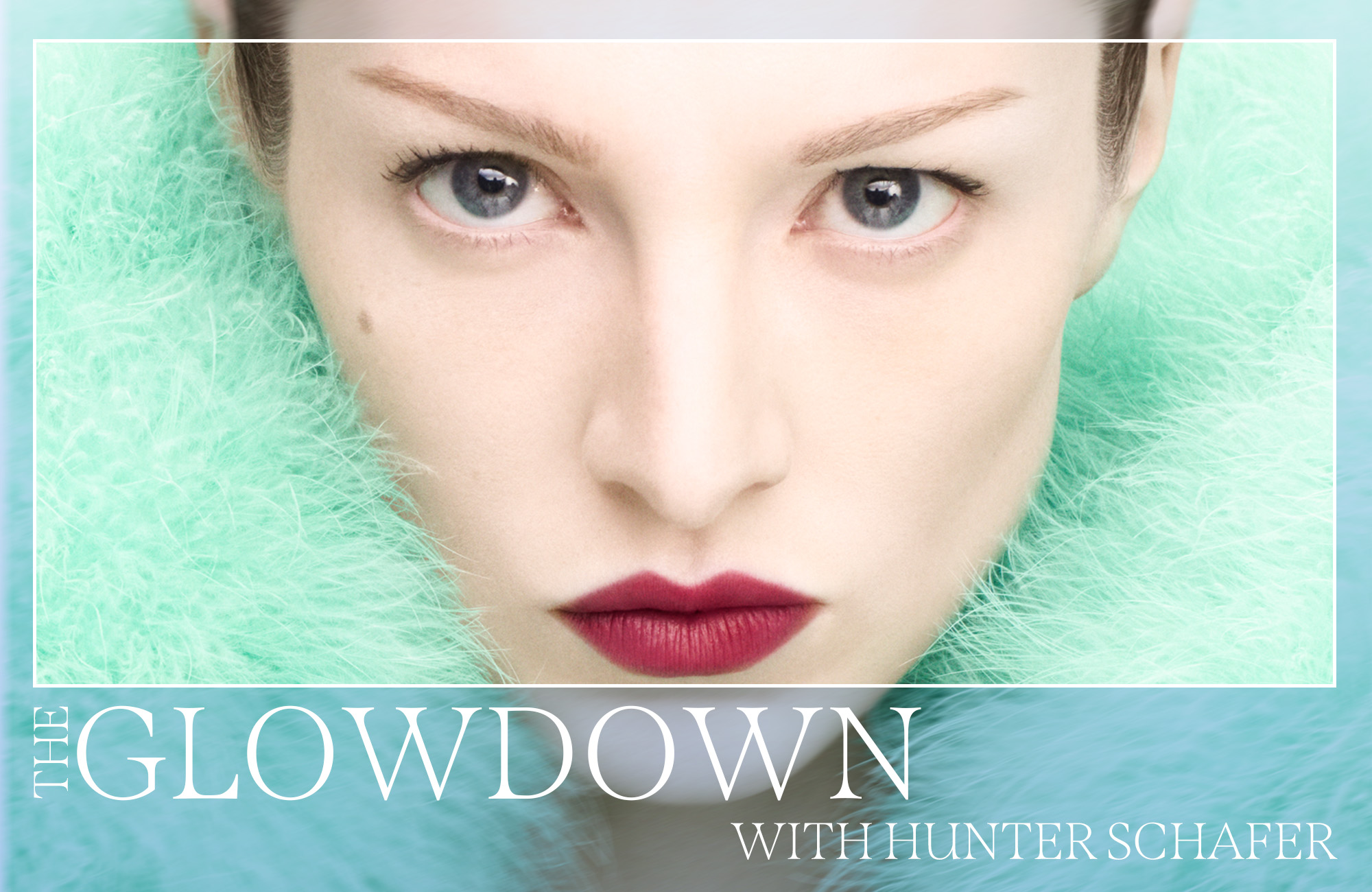 Hunter Schafer in a turquoise fluffy jacket wearing a bold red lipstick