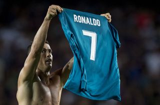Cristiano Ronaldo holds up his shirt after scoring for Real Madrid against Barcelona in the Supercopa at Camp Nou in 2017.