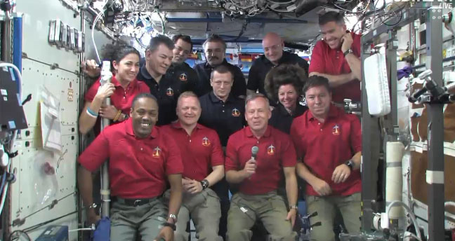 The STS-133 and Expedition 26 crew members gather in the Destiny laboratory of the International Space Station to speak with President Barack Obama on March 3, 2011.