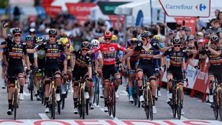 Sepp Kuss celebrates his overall win with Jumbo-Visma teammates while crossing the finish line in Madrid