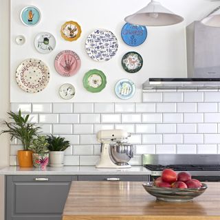 kitchen area with white wall tiles and plates