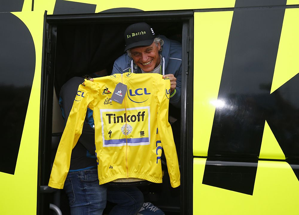 Oleg Tinkov holds up the yellow jersey