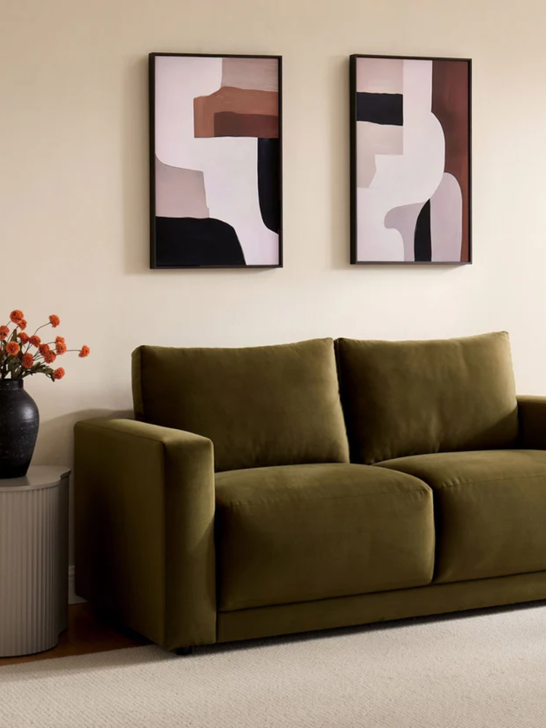A green two-seater sofa from DUSK