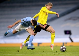 Erling Haaland, right, takes on Manchester City’s Ruben Dias in the Champions League